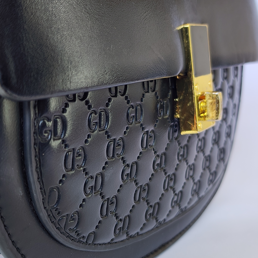 The Noir Monogram Saddle Bag – Edgy & Bold