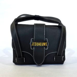 Pre-loved small black structured flap bag featuring white contrast stitching and gold lettering.