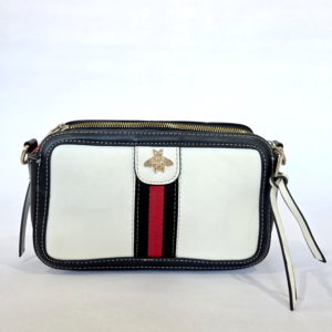 Pre-loved white and black camera crossbody bag featuring a red and black center stripe and a gold metallic bee.