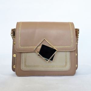 Pre-loved two-tone tan and cream flap bag featuring gold chevron embroidery and a black geometric front clasp.