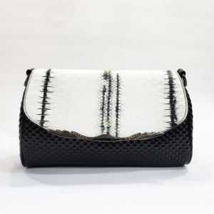 Pre-loved black and white flap bag featuring a faux-snakeskin top, a glossy bubbled black bottom, and ornate edge hardware.